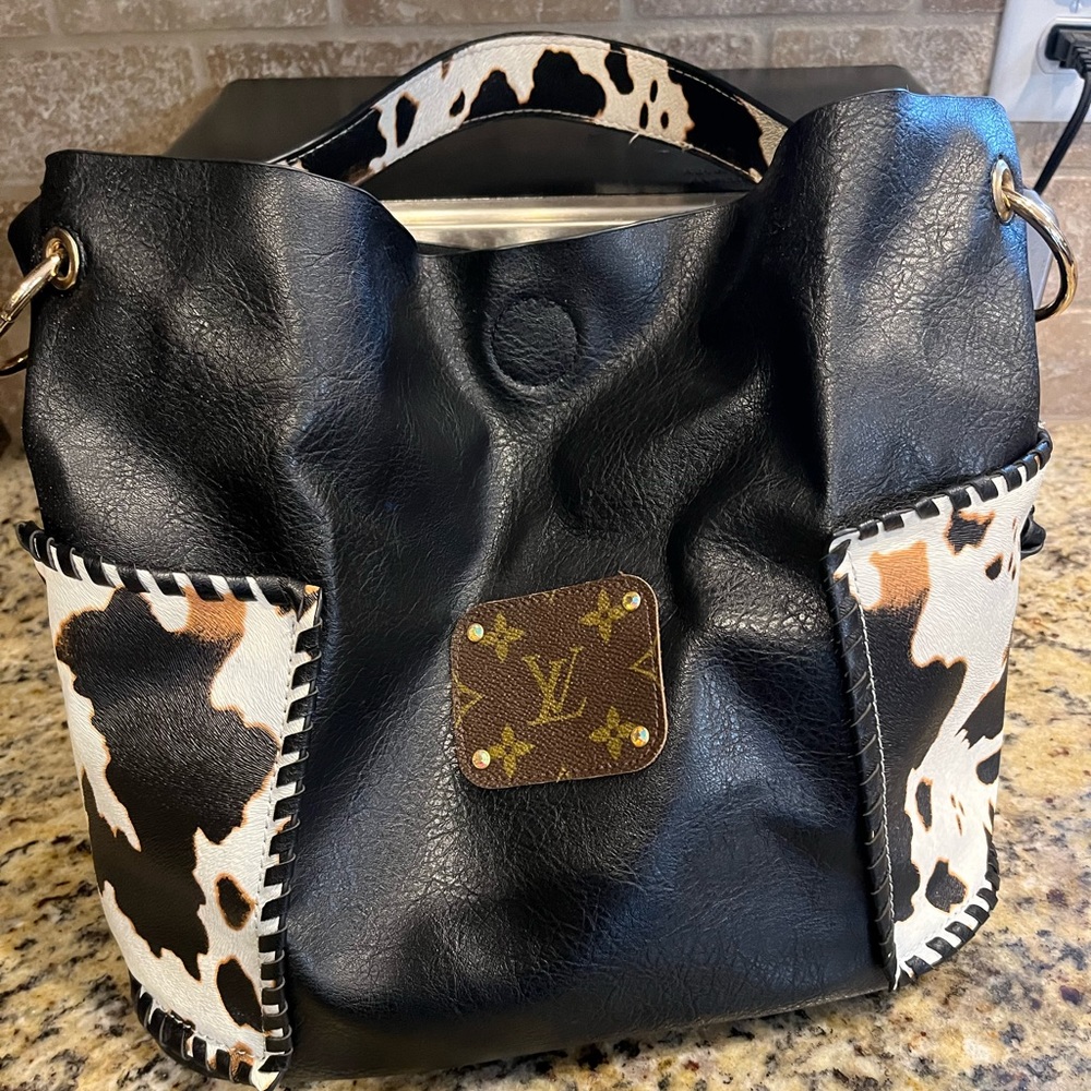 Black and cow skin pattern purse.  Lightly worn. Came from local boutique.